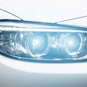 Closeup headlights of modern car during turn on light in night