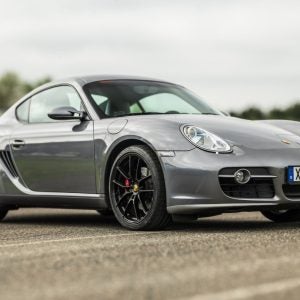 Grey Porsche Cayman parked on empty street